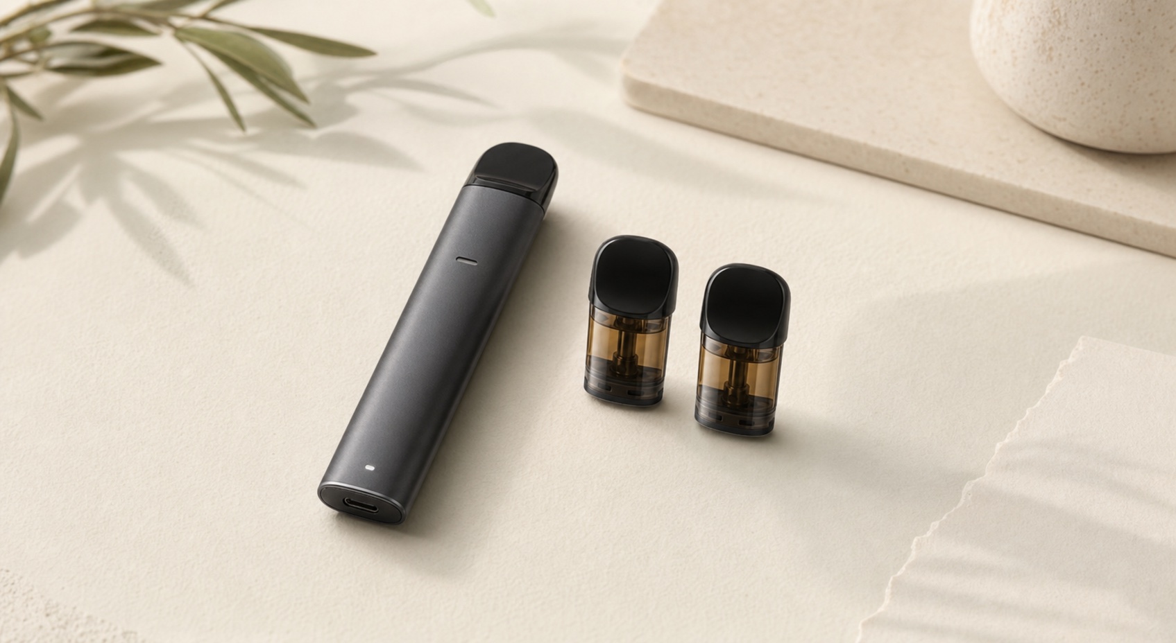 Generic pod vape device beside two matching pods on a warm neutral tabletop